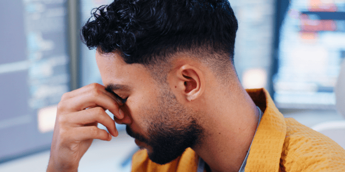 Man looking at himself in the mirror after a meaningful style change