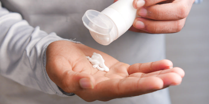 Man applying erection-enhancing cream to penis for improved blood flow and stronger, longer erections.