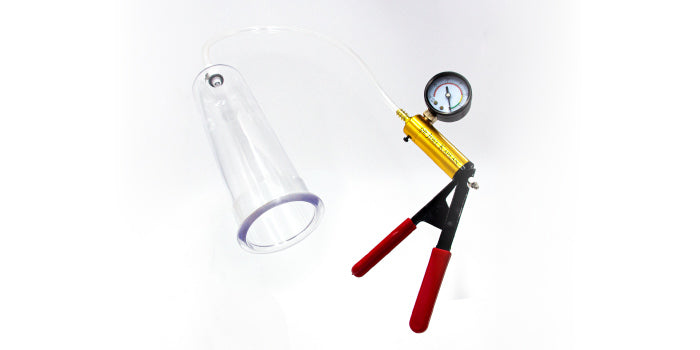 Electric vacuum erection pump kit with clear cylinder, digital pressure gauge and constriction rings on a bedside table.