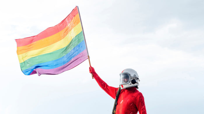 Astronaut with helmet holding lgbt flag