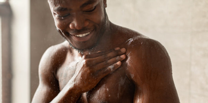 Man using intimate hygiene products in the shower for better men's wellness and intimate health care.