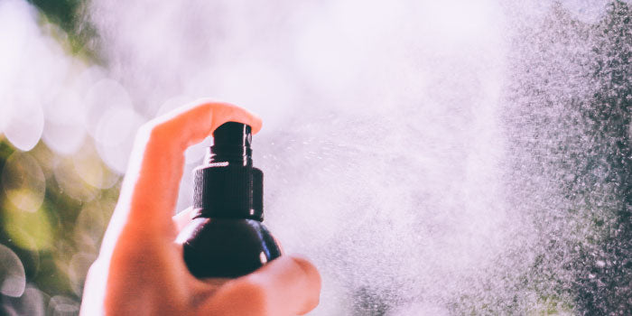 Man applying intimate deodorant as part of his personal hygiene routine.