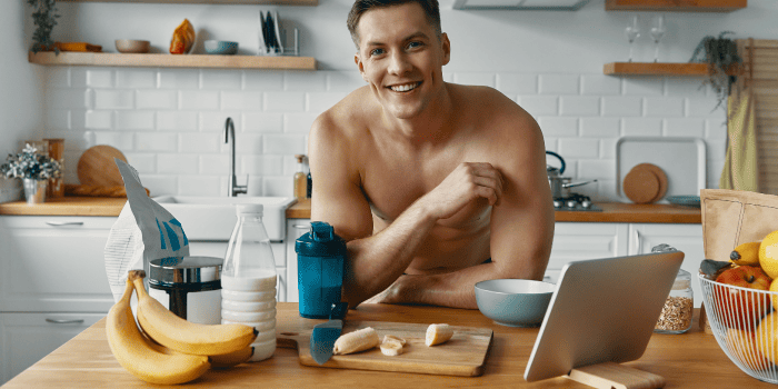 Man in the kitchen preparing a healthy meal, representing the impact of nutrition on health and well-being.