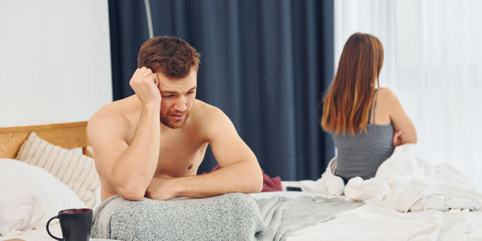 Couple embracing on a couch, practicing mindful cuddling to reduce sexual performance anxiety.