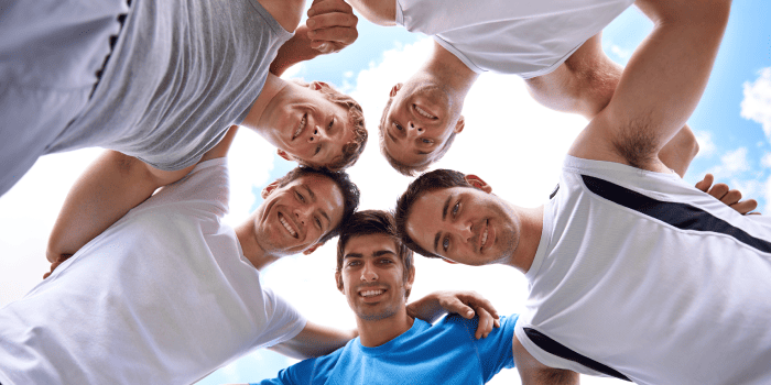 Group of men in a respectful, intimate setting exploring their sexuality consensually.