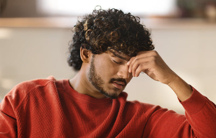 Couple embracing on a couch, practicing mindful cuddling to reduce sexual performance anxiety.
