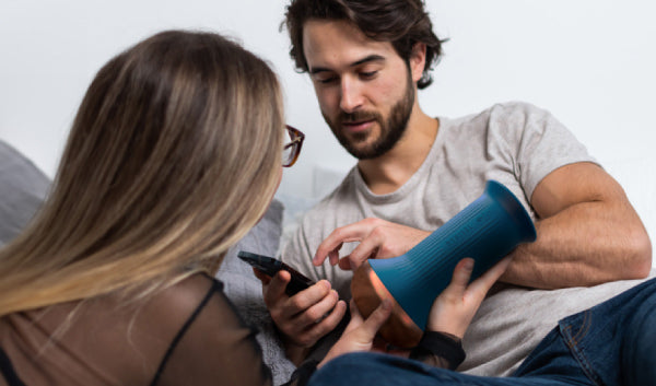 Man confidently using a next-generation electronic erectile-dysfunction device at home for discreet, personalized therapy