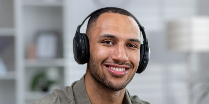 Relaxed man with headphones enjoying a sound therapy session for sexual arousal.