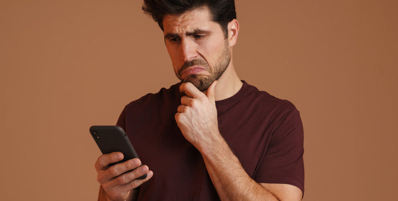 Smartphone displaying a TikTok feed of sexual health tips with warning icons and question marks.