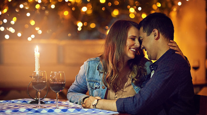 Couple in a romantic date having dinner and wine