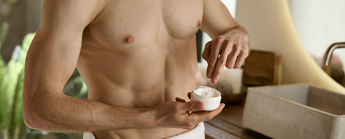 Skincare products alongside a Myhixel Ring on a bathroom shelf, illustrating men’s intimate health care.