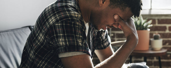a black man crying with anxiety