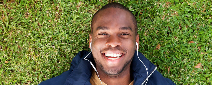 a happy man lied on the grasss