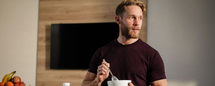 a man having a healthy breakfast in a kitchen