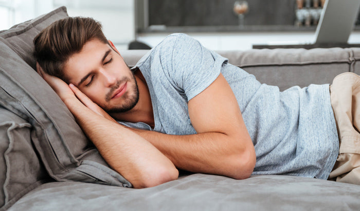 Man sleeping peacefully in bed, representing nocturnal erections and male sexual health