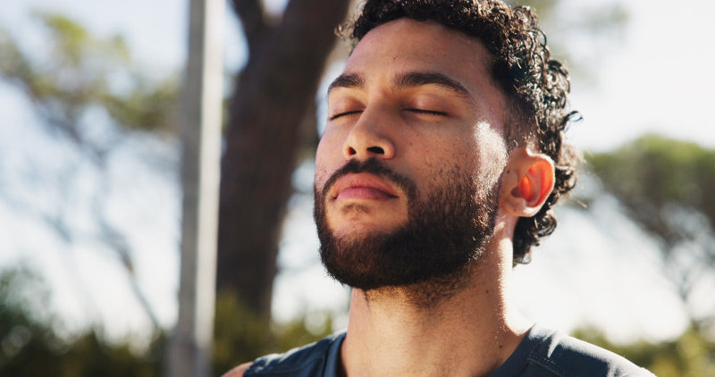 Man outdoors in spring sunlight, representing increased confidence and feeling more attractive during the season