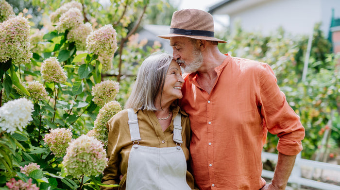 old couple in love kissing in the garden